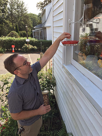 filling the hummingbird feeder